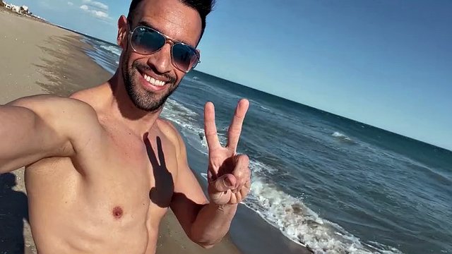 Naked sexy latin man on a public beach