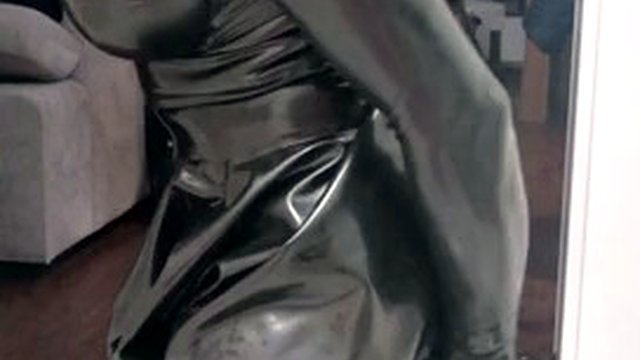 Rubber latex sissy in gas mask plays with a dildo