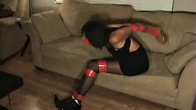Black woman tied up and gagged with red tape