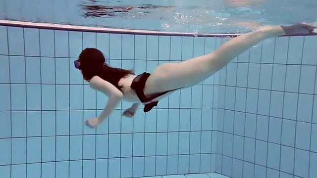 flast as a pancake roxolana swims naked underwater with a diving mask