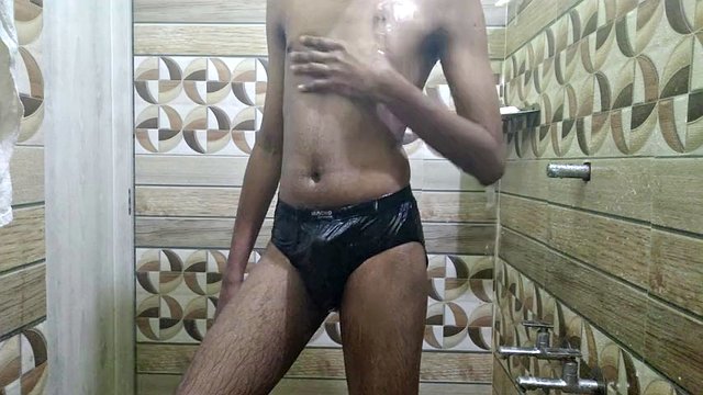 Young man with a perfect body bathing in his underwear