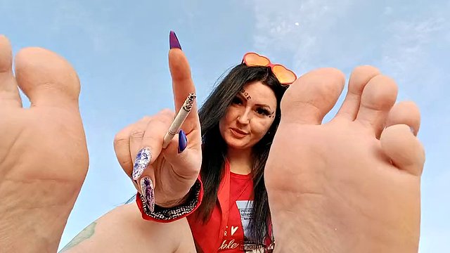 Foot fetish on the beach by the sea. Mistress Nika smokes and seduces you with her feet and toes