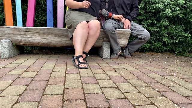 Mother-in-law masturbates her stepson's cock in a public park